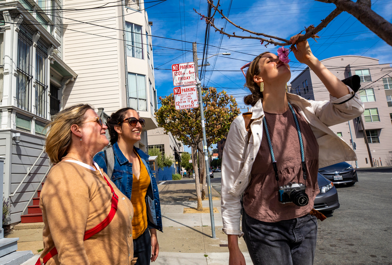 Hope stops to smell a flower with friends 