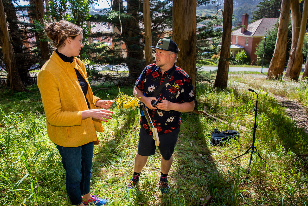 Hope speaks to a man practicing music in the Golden Gate Park 