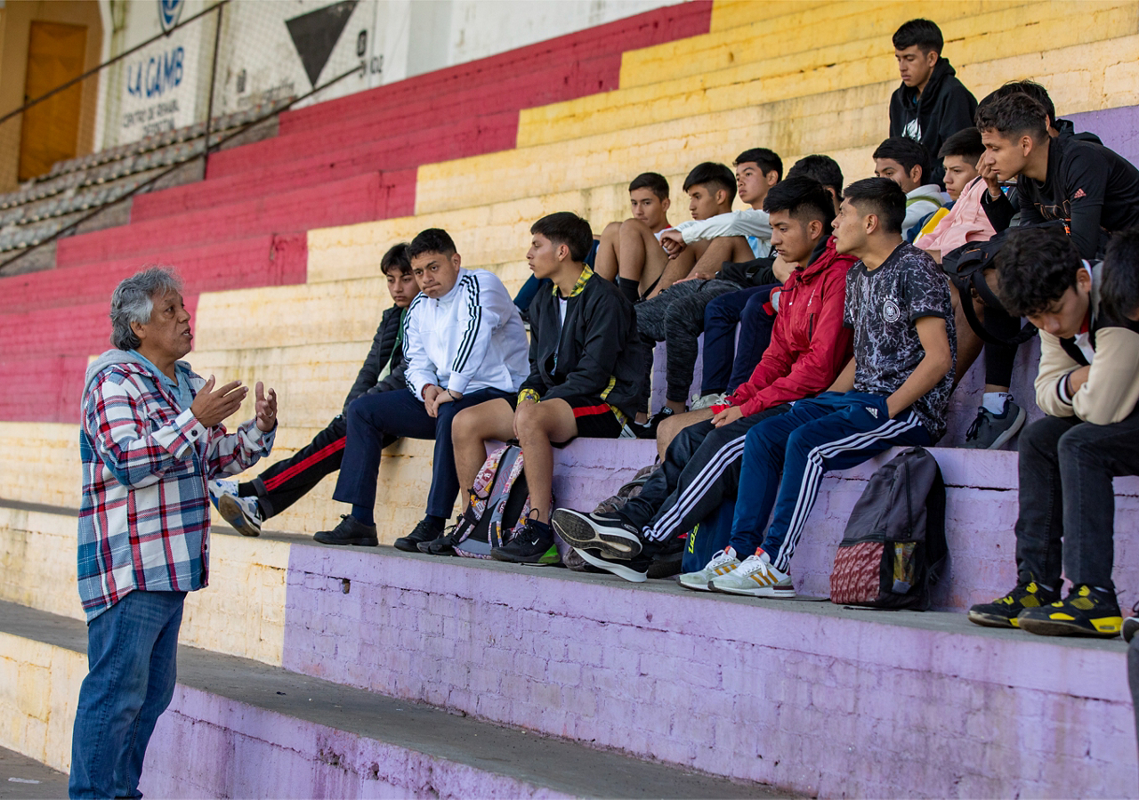 Cristobal invites members of the youth division of San Pedro Soccer Club to begin an AIA team Bible study.