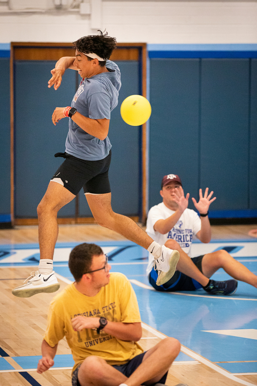 a game of dodgeball in a gymnasium