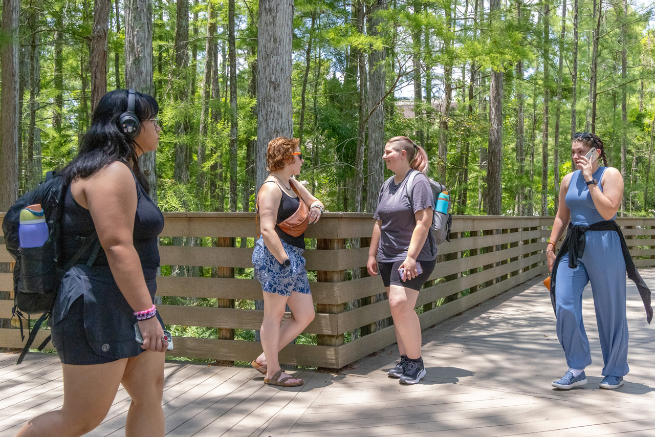 At the heart of the University of Central Florida’s campus, Lillian and Rose (near the fence) prepare for their next conversation with students.