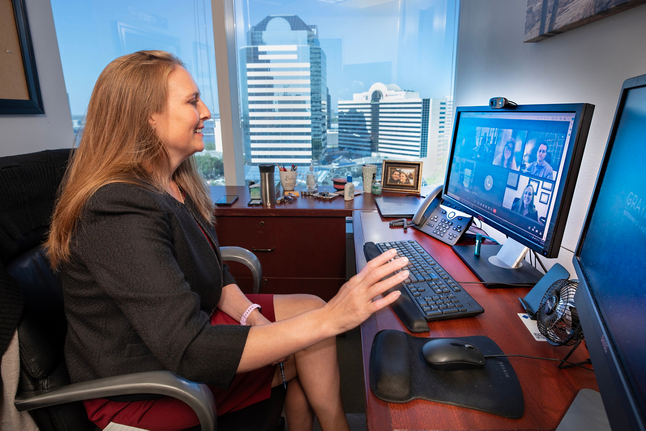 Jennifer Vanover, attorney with FLAG ministry. Jen talking with Cru legal office about status of different projects. Jen is in her office on the 11th floor downtown. 