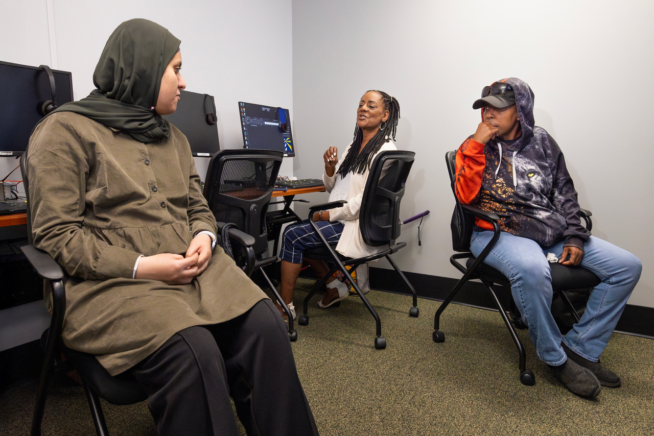 Lorna Johnson, losing sight article. , Lorna learning Microsoft Word for blind or losing sight. She uses a computer pad to help take notes with large print. Her blind instructor, James Oates is standing and wearing black. The computer talks and reads everything the curser goes over. Lorna is taking classes at Lighthouse, a training center for people losing their sight. 