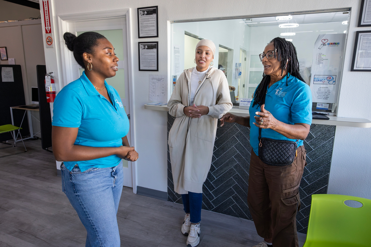 Lorna Johnson, losing sight article. Lorna helps people with their paperwork at UP, United against poverty. Here she is talking with co-workers. 