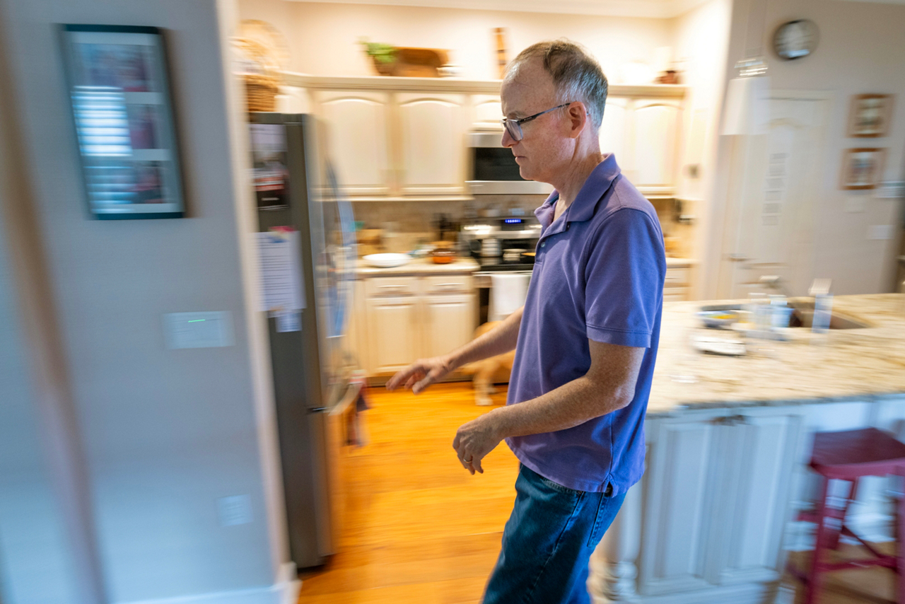 John Powers, blindness article, John walking around his house carefully. 