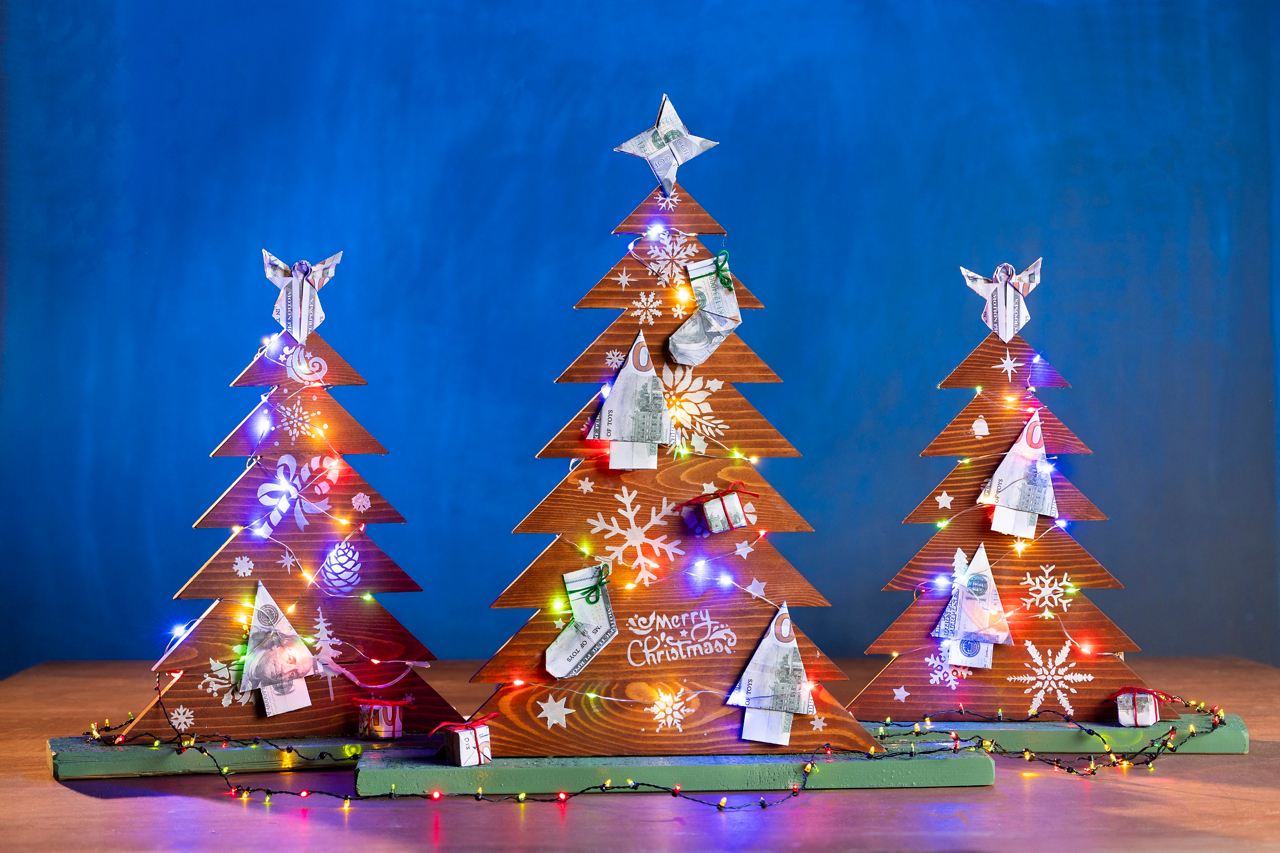 Wood Christmas trees with origami money ornaments. They are for a Cru.org article titled "How not to go broke over the holidays". 