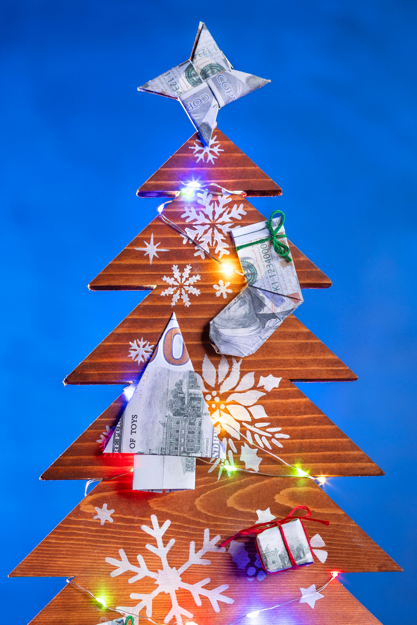 Wood Christmas trees with origami money ornaments. They are for a Cru.org article titled "How not to go broke over the holidays". 