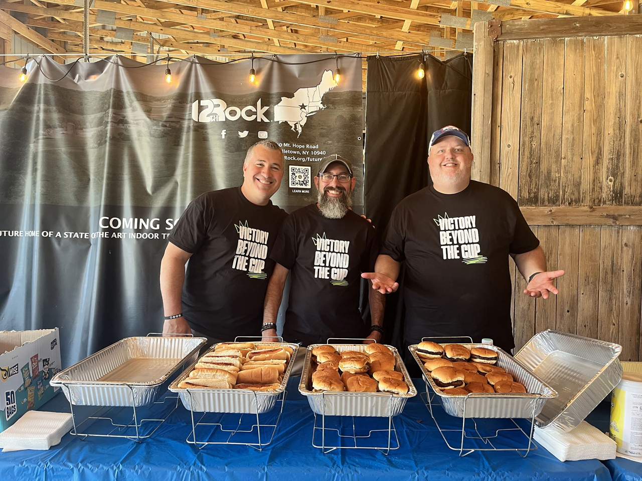 Men smiling in front of food