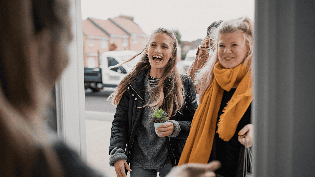 Women smiling outside of door
