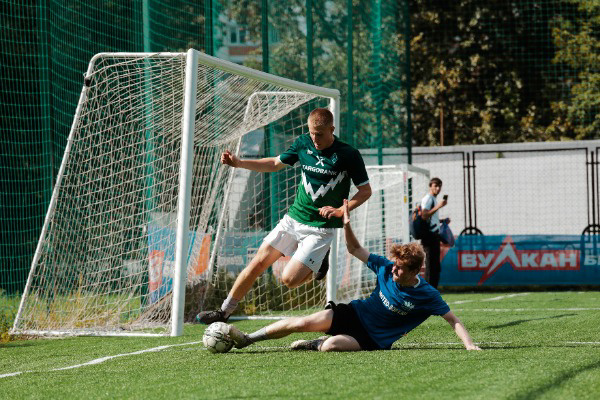 Two soccer players battling over the ball