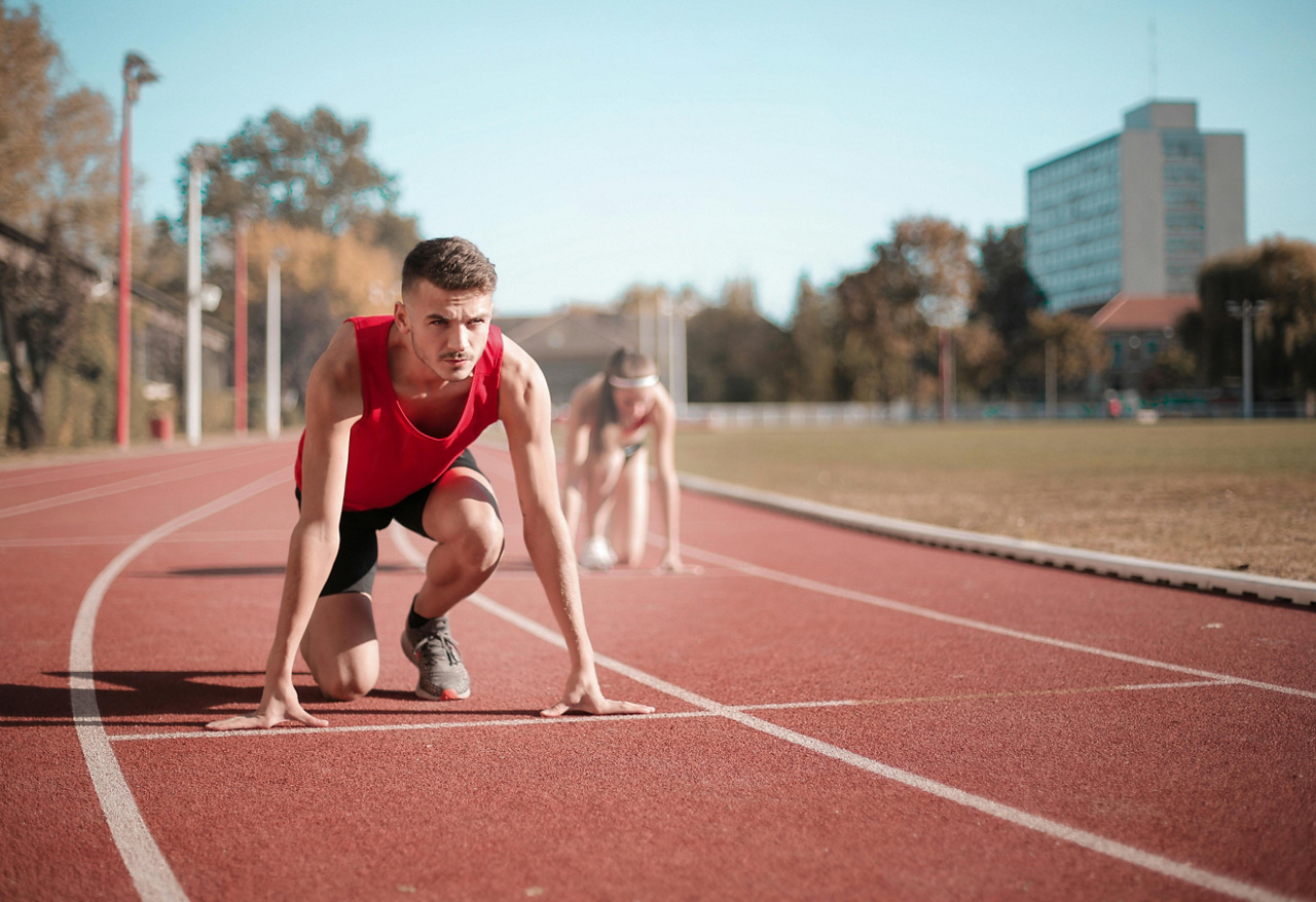 Man and Woman setting up for a race on the track.