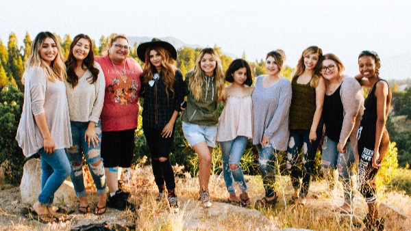 Students posing for a picture in a field.