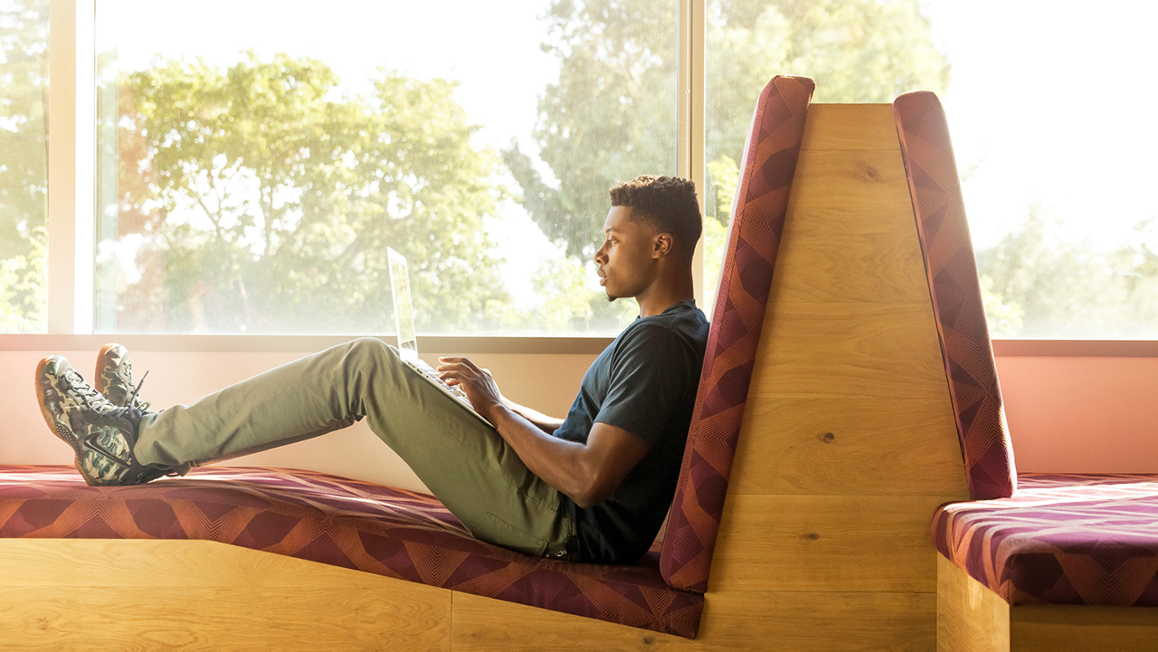 Person with bible on table and journal out.