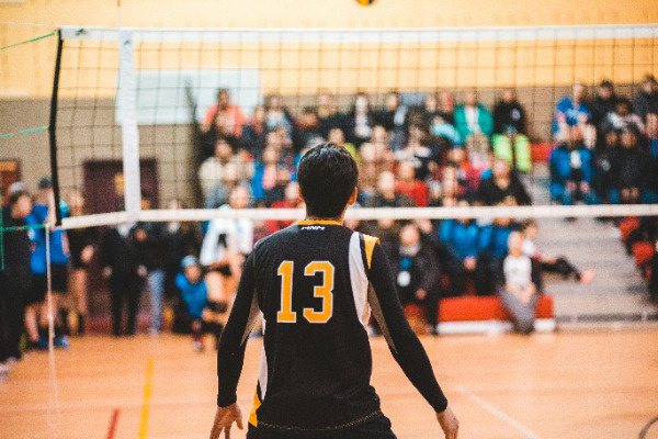 Volleyball player ready to hit incoming ball.