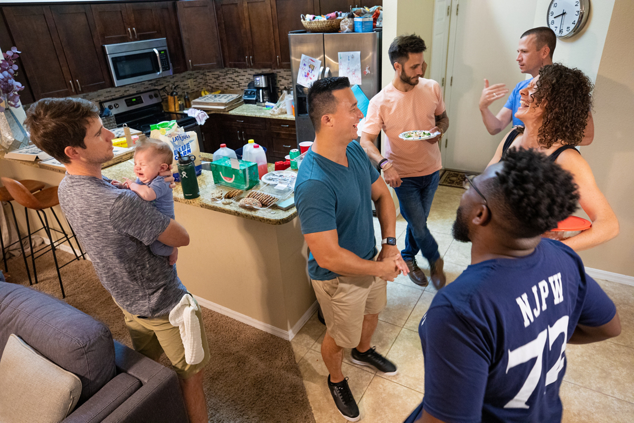 friends laughing in kitchen