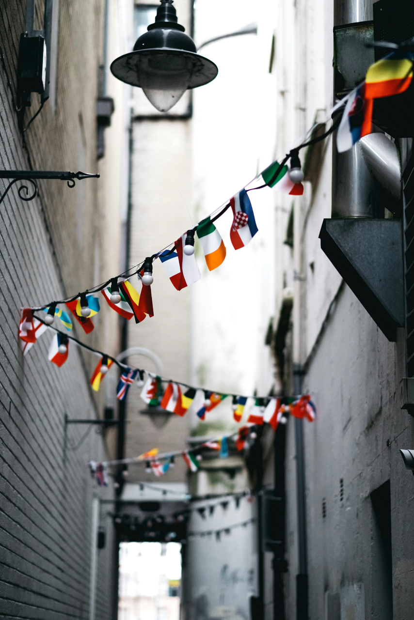 Country flags hung up along a path.