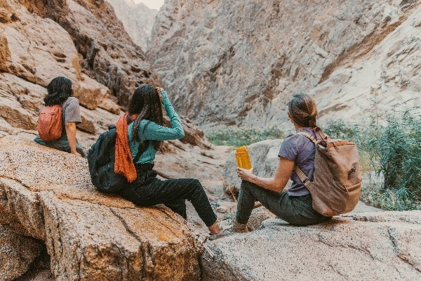 People resting on a hike through canyons.