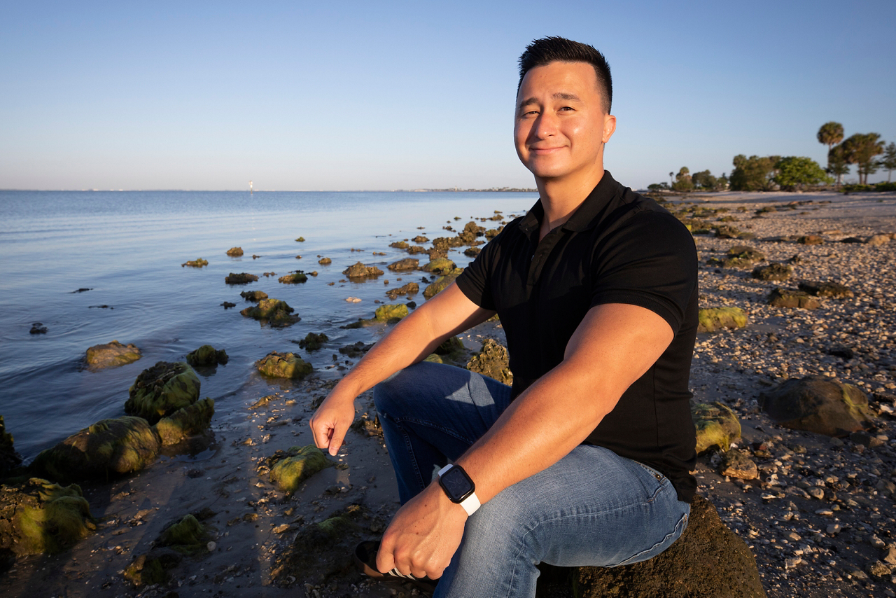 man sitting by water