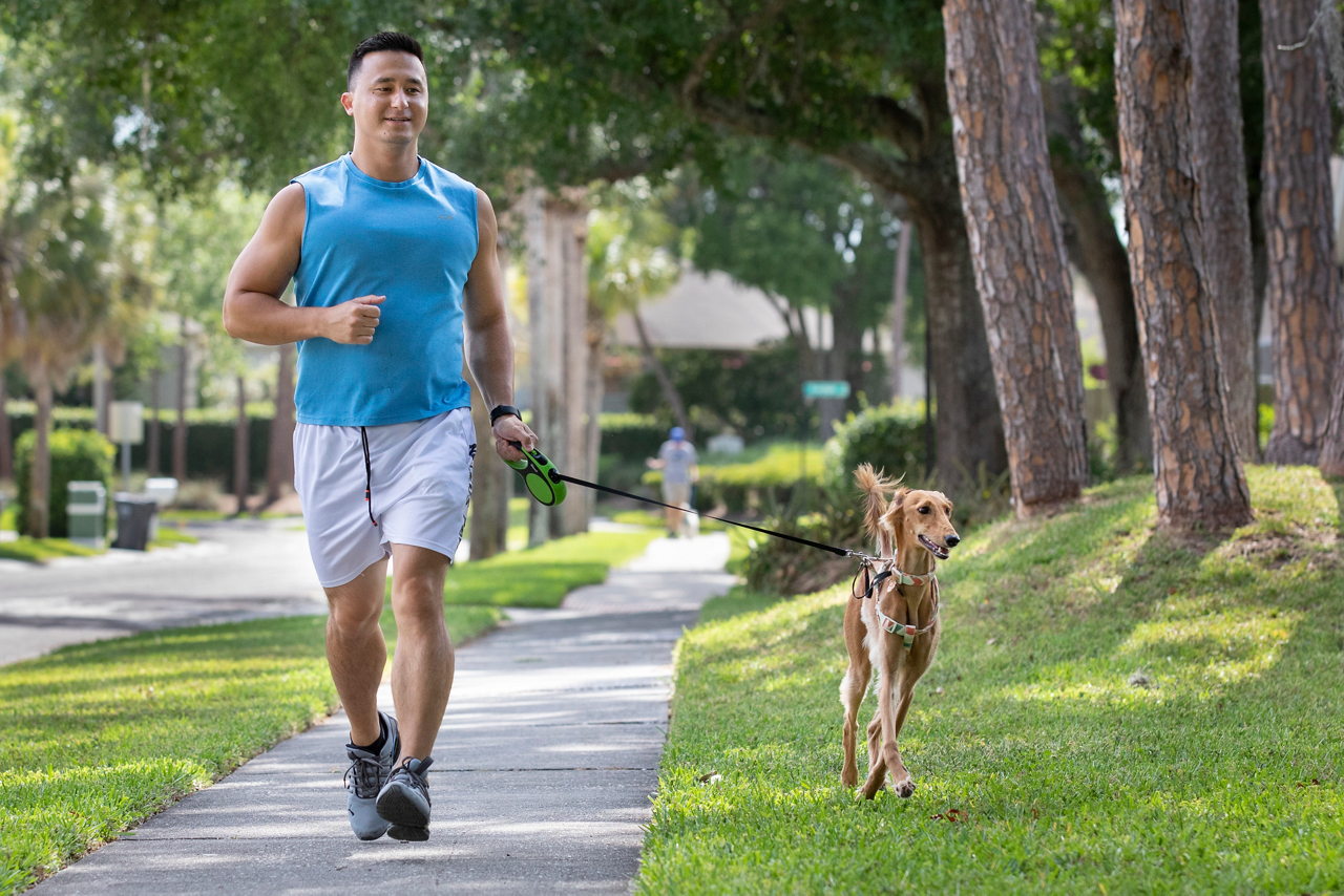 man running with dog