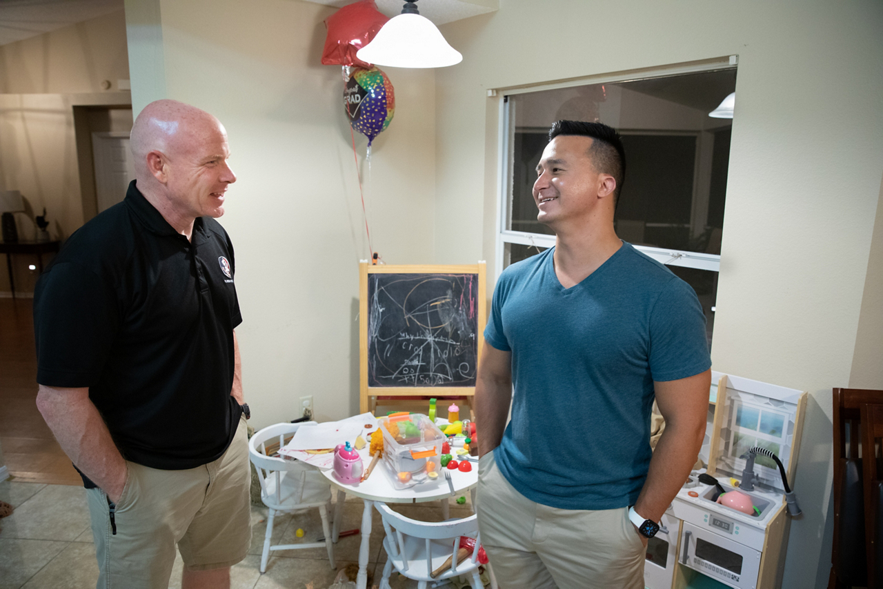 men talk in living room