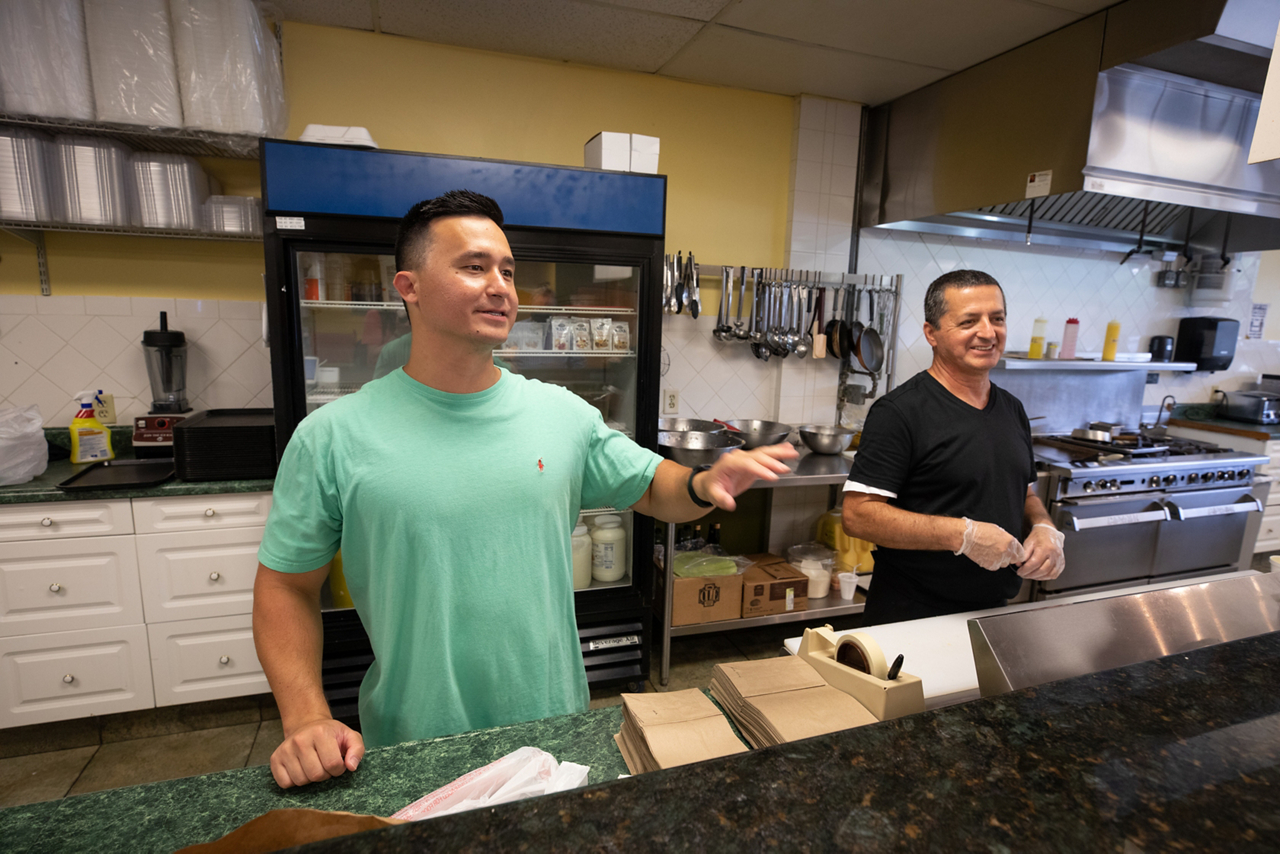men behind food counter