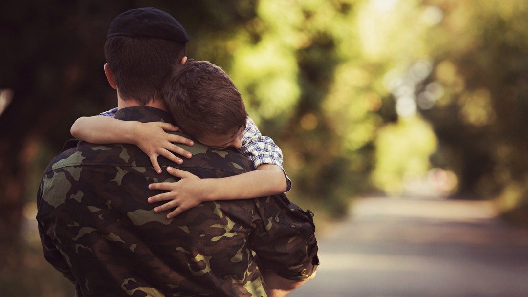 Little boy and soldier in a military uniform