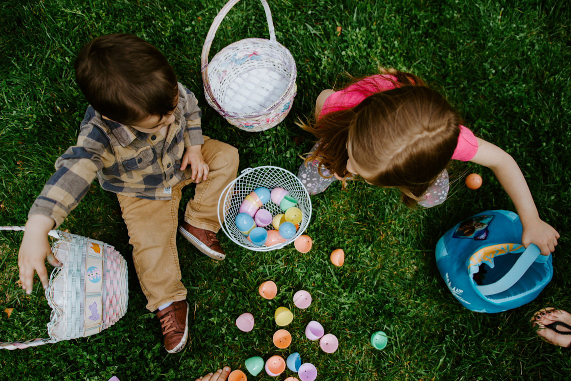 Kids playing with easter eggs in grass