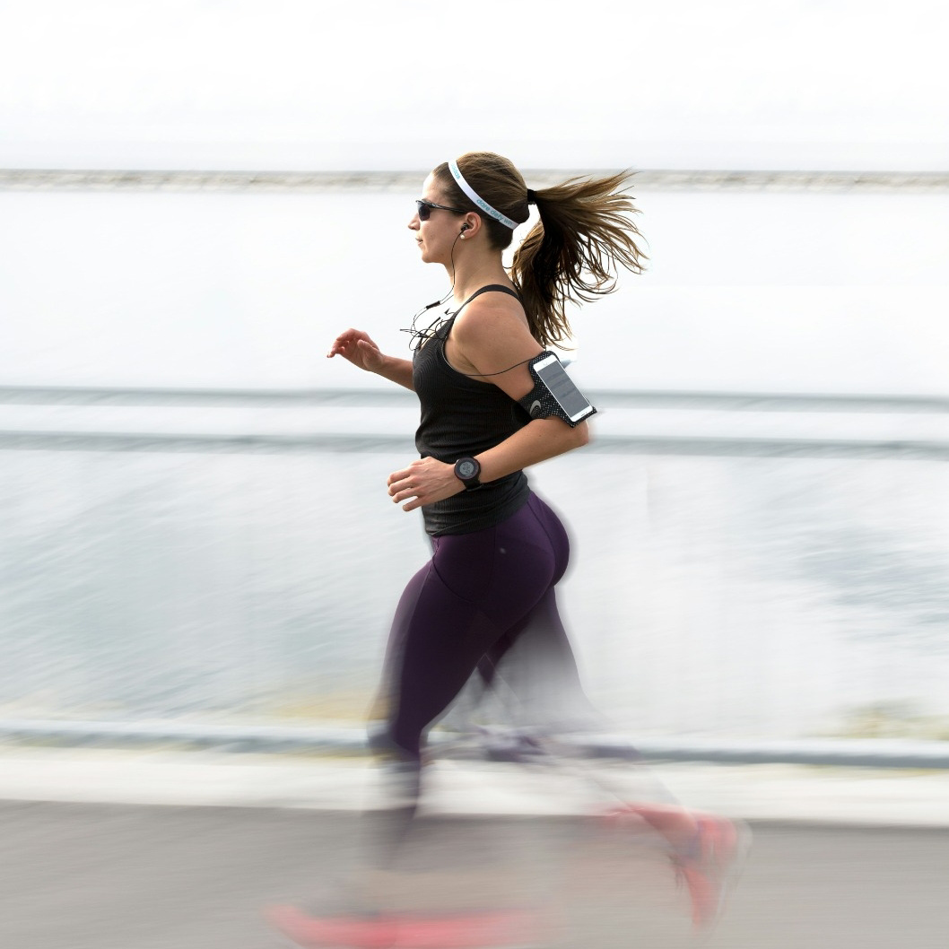 woman running for fitness along a path