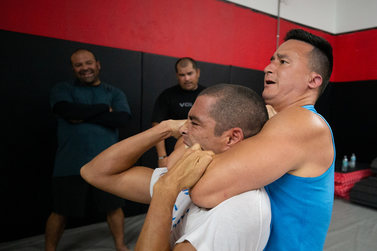 man holds opponent in choke hold