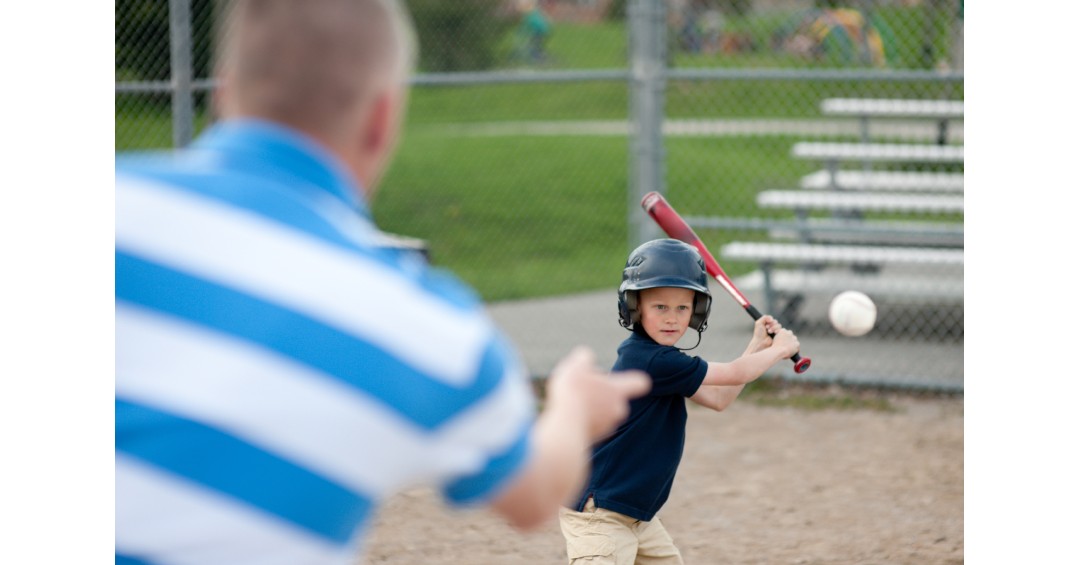 A father playing baseball with his son