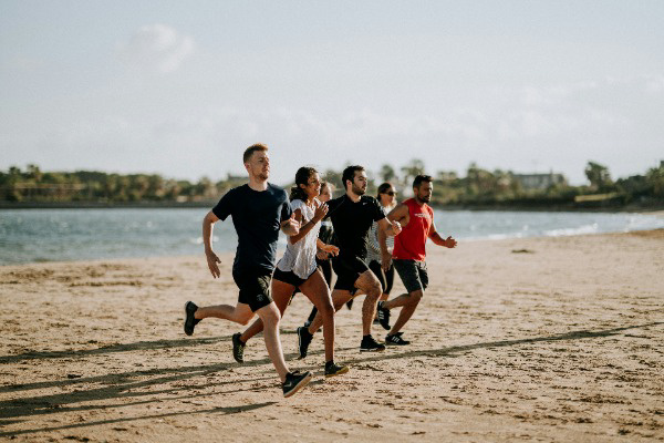 Group running on the beach as part of a workout.