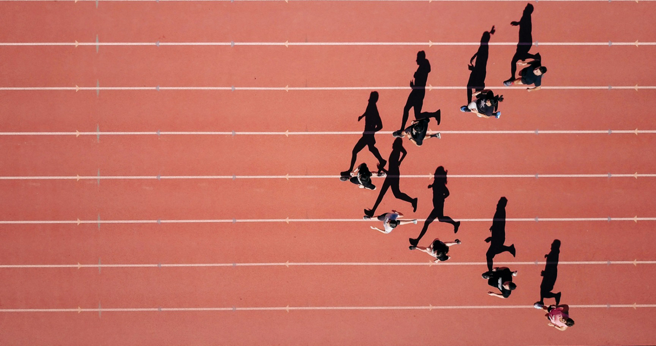 People running in formation on a track.