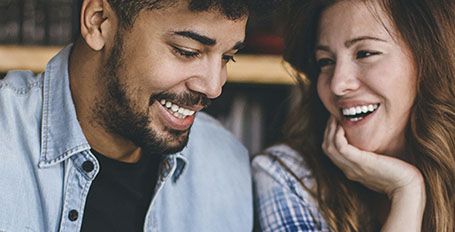  Young couple sitting together and smiling