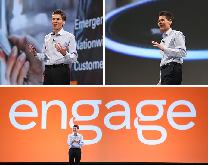 Engage with Fiserv President and CEO Jeff Yabuki gives a speech in front of a screen