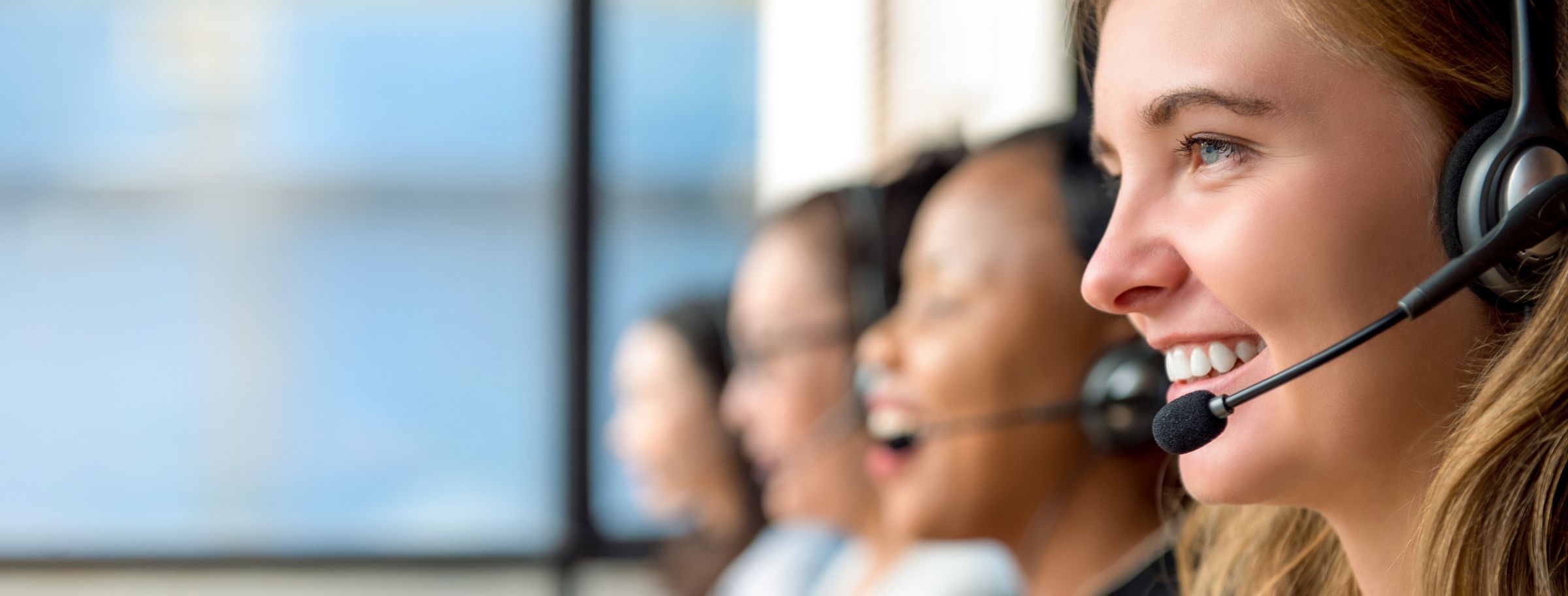 a group of women wearing headsets sitting in a row