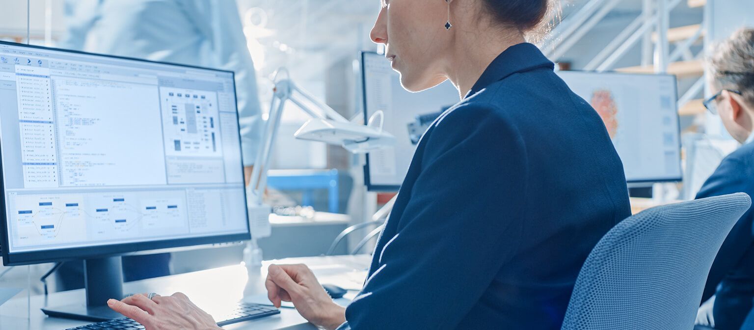 a woman sitting at a desk using a computer