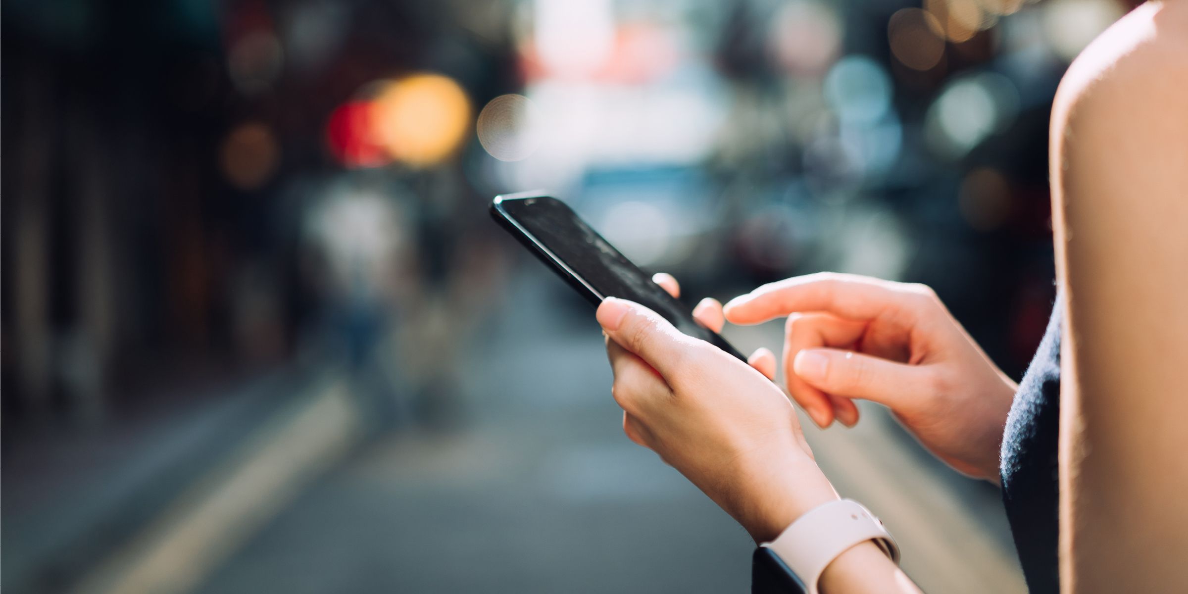 woman's hands typing on phone