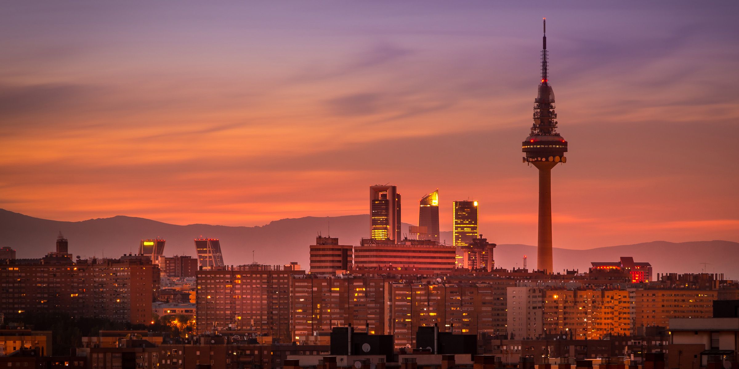 a city skyline with a tall tower