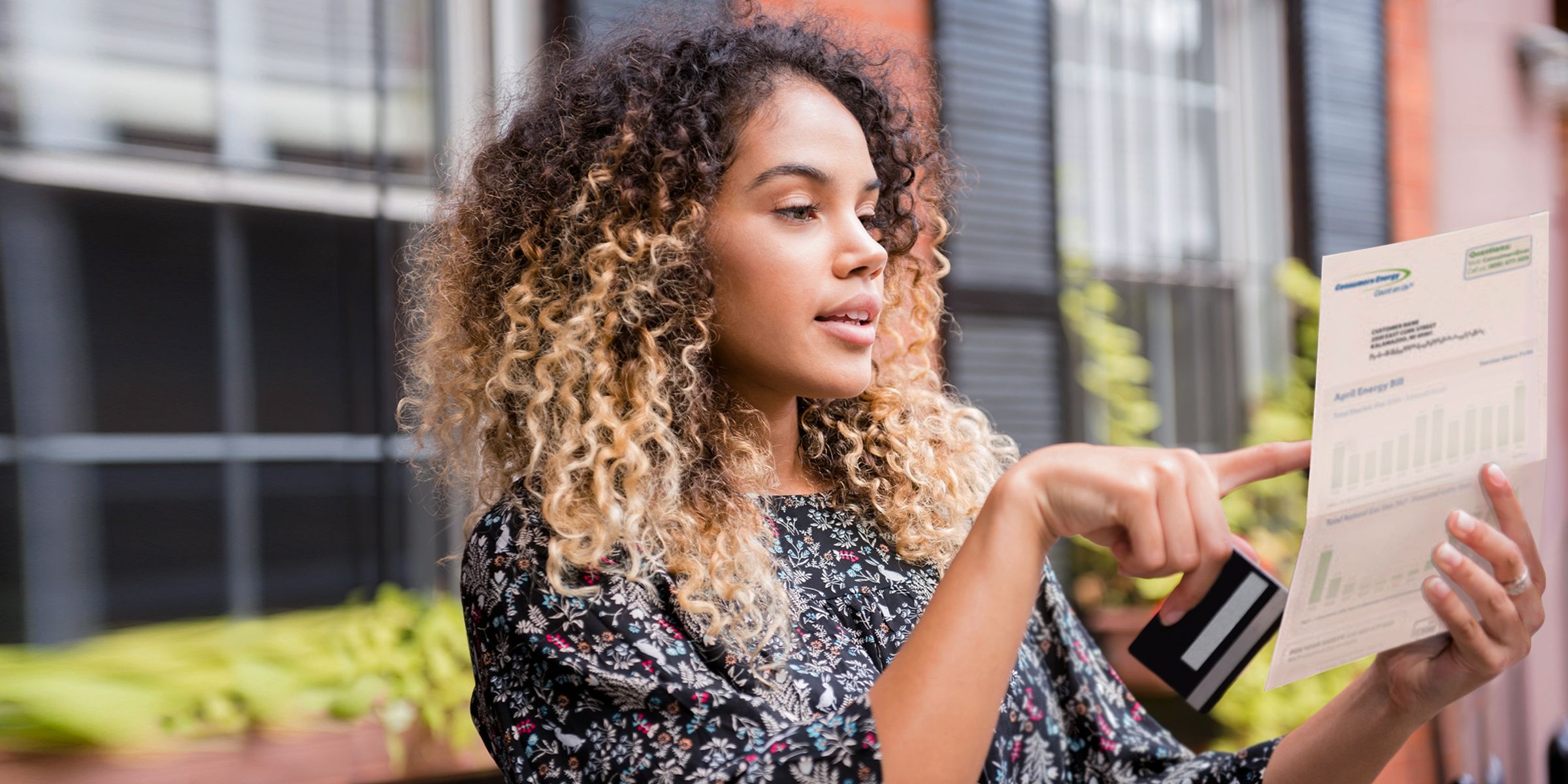 a woman with curly hair holding a paper