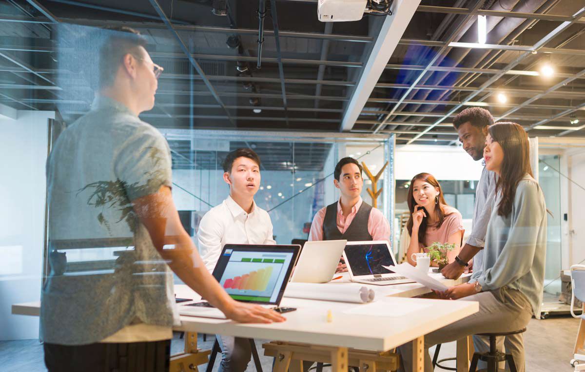 Group of diverse business team working on strategy in an open office setting