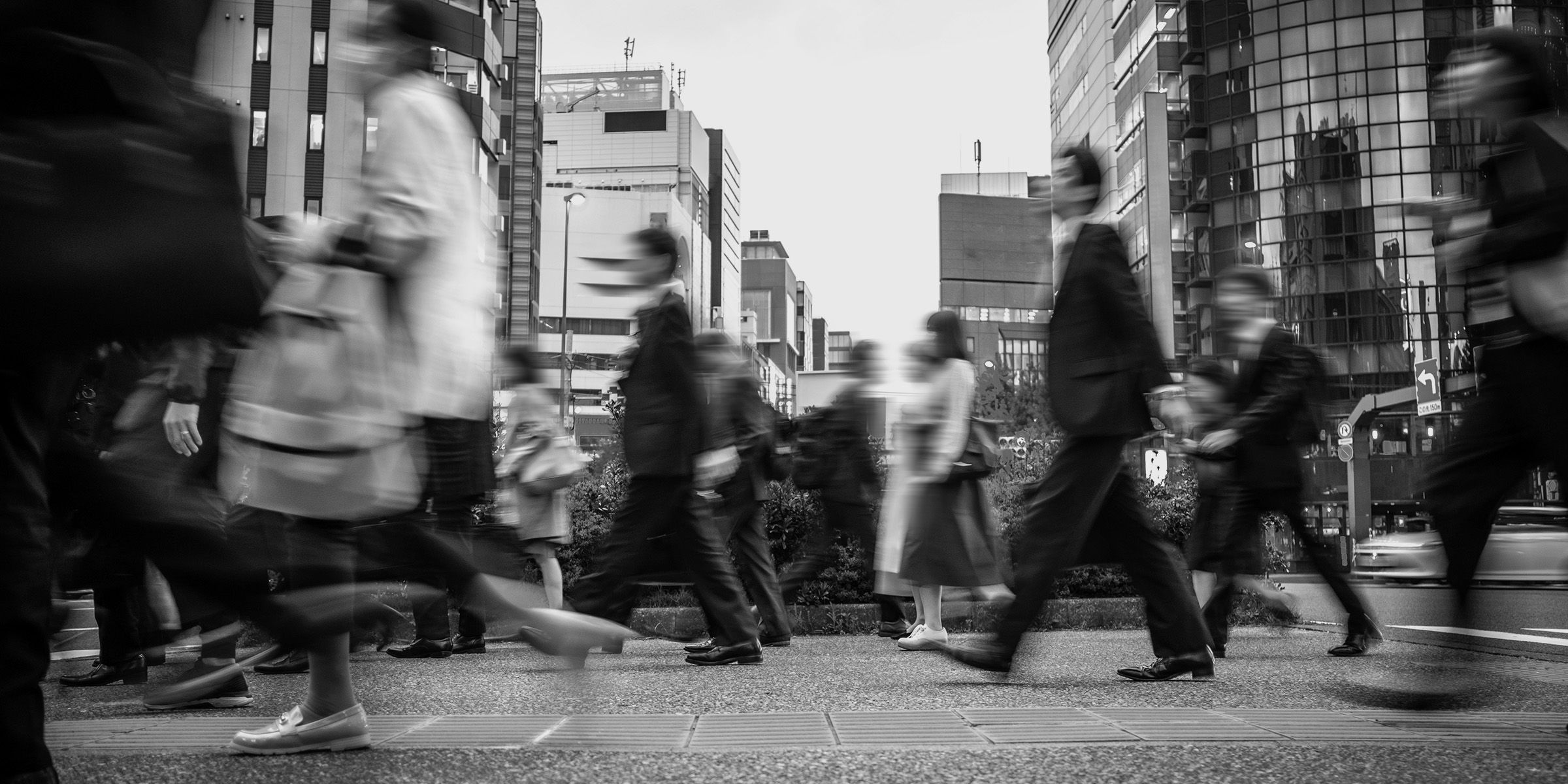 photograph of diverse people in motion walking in a city