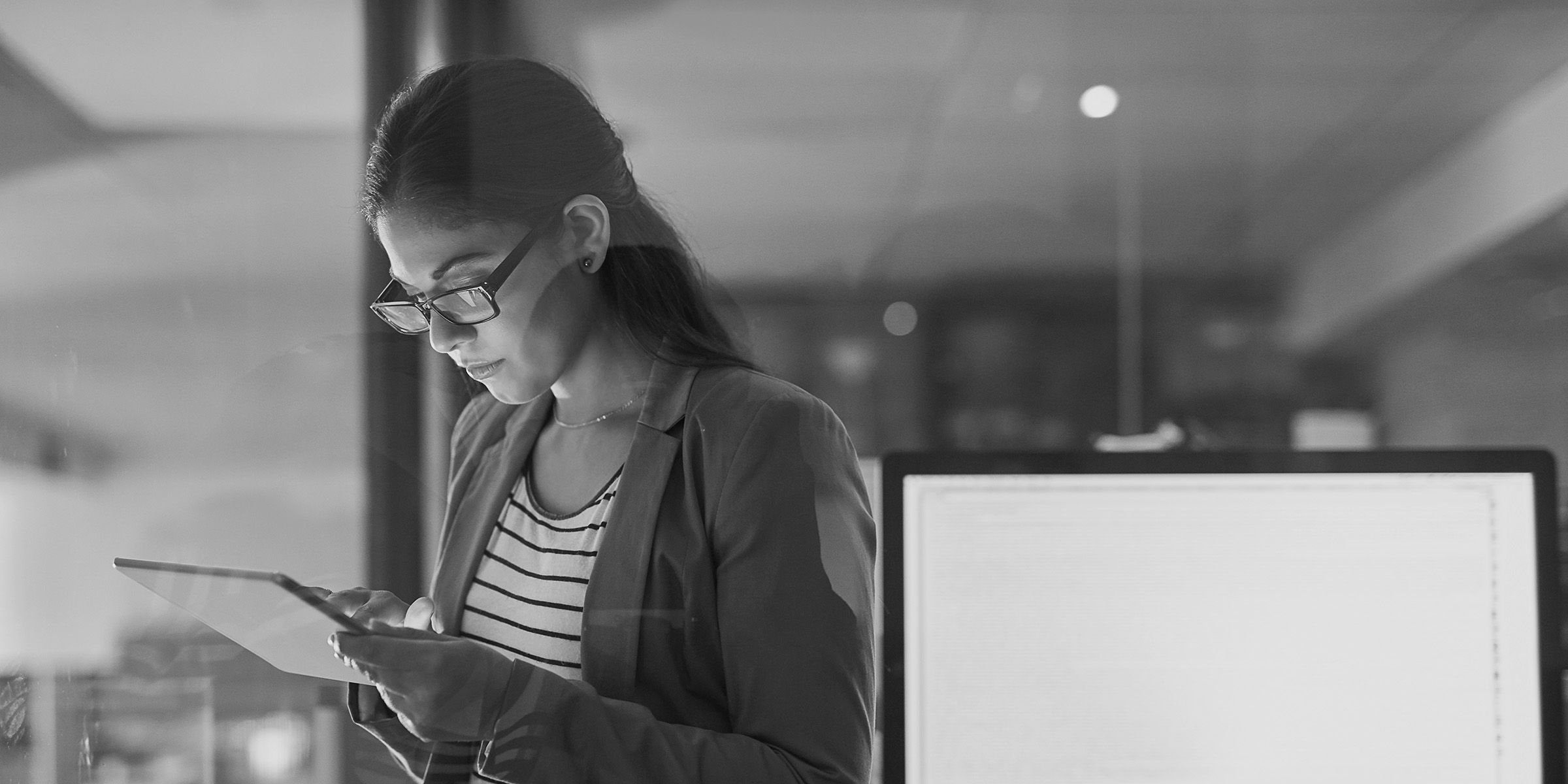 Female-presenting person looking at their tablet device