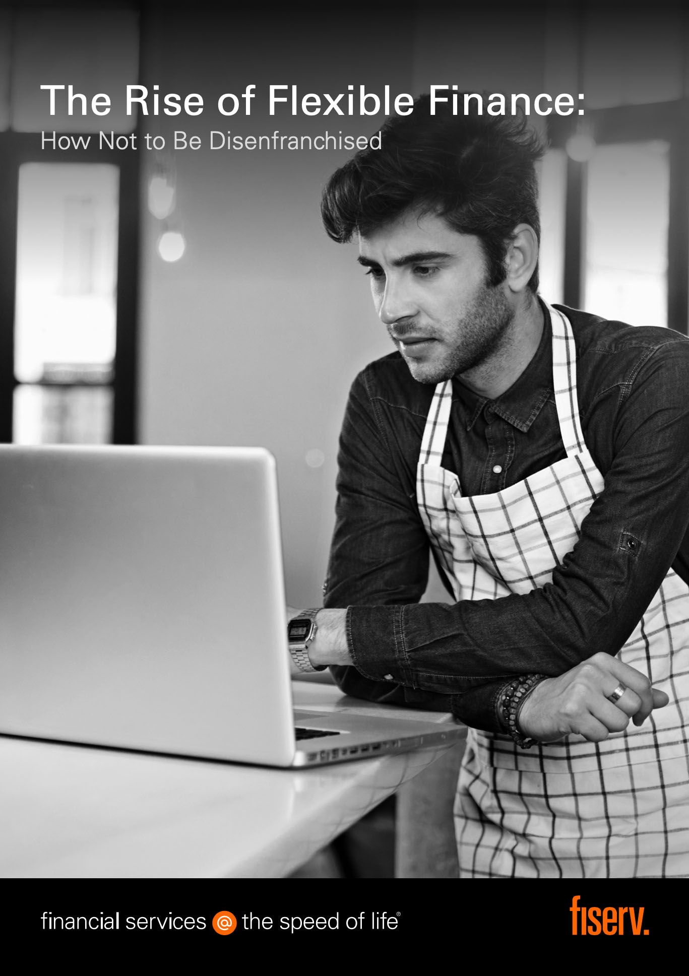 a man sitting on a couch using a laptop
