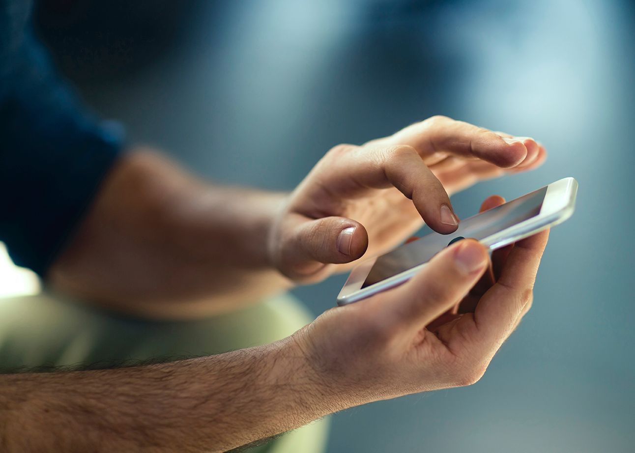 Man's hands holding phone