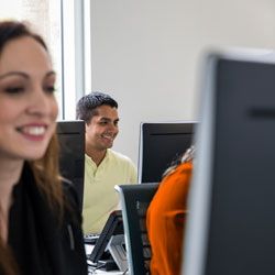 a group of people working on computers