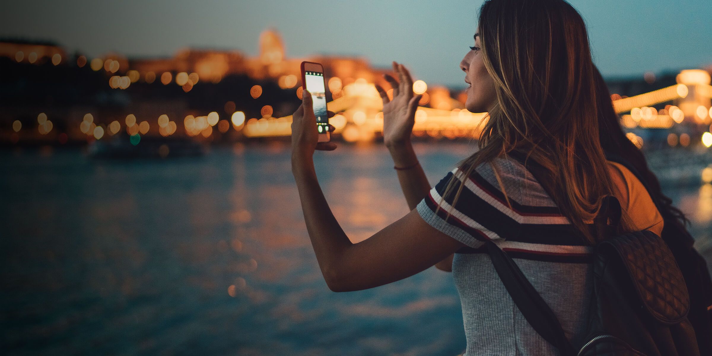 a woman taking a picture of a city