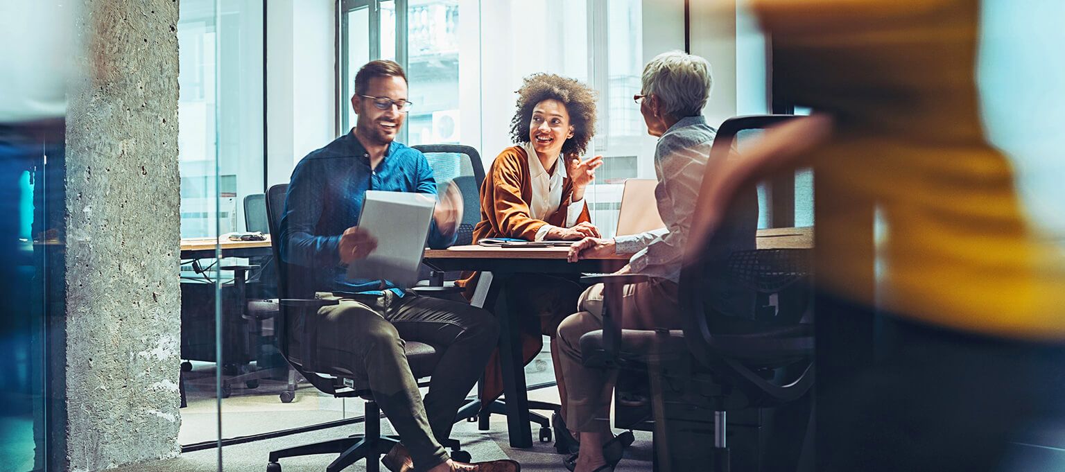 a group of people sitting and talking on a table