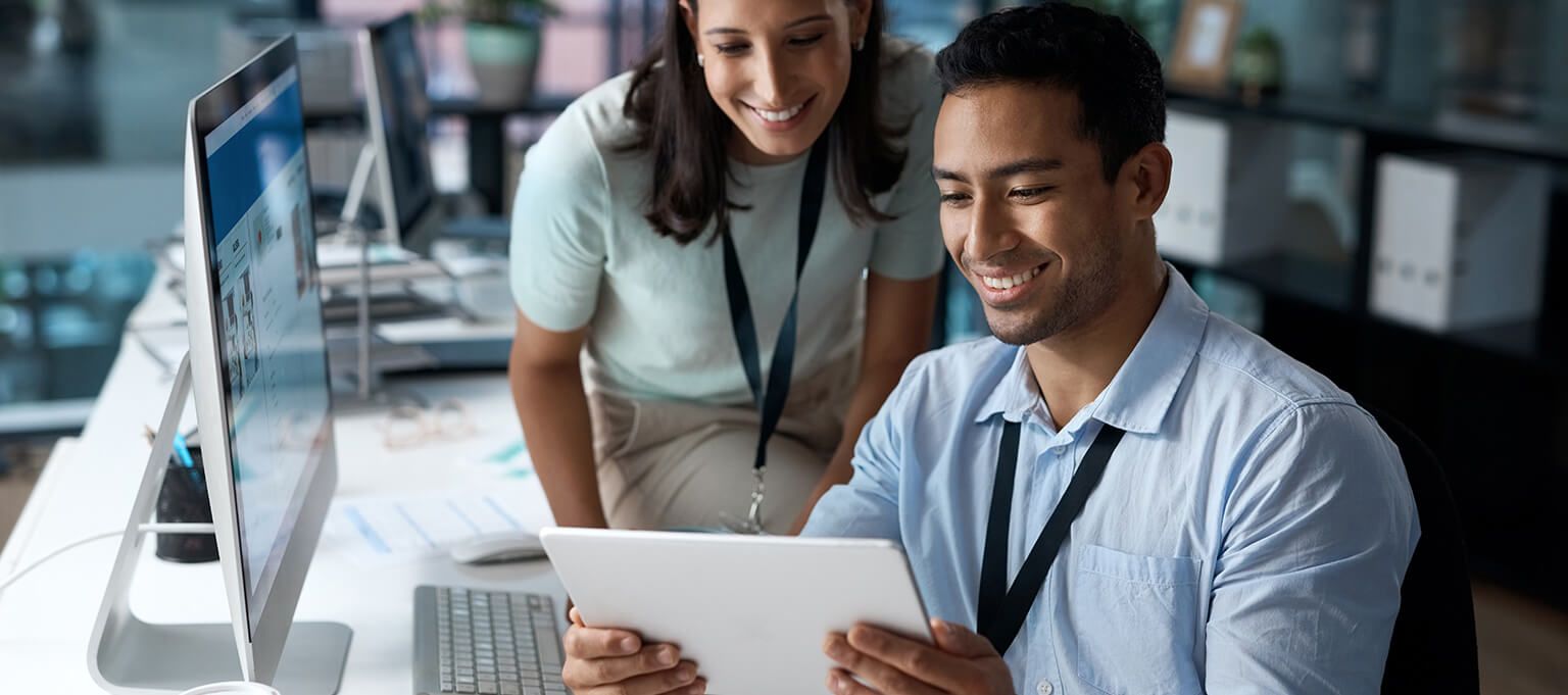 Smiling man and woman looking at report