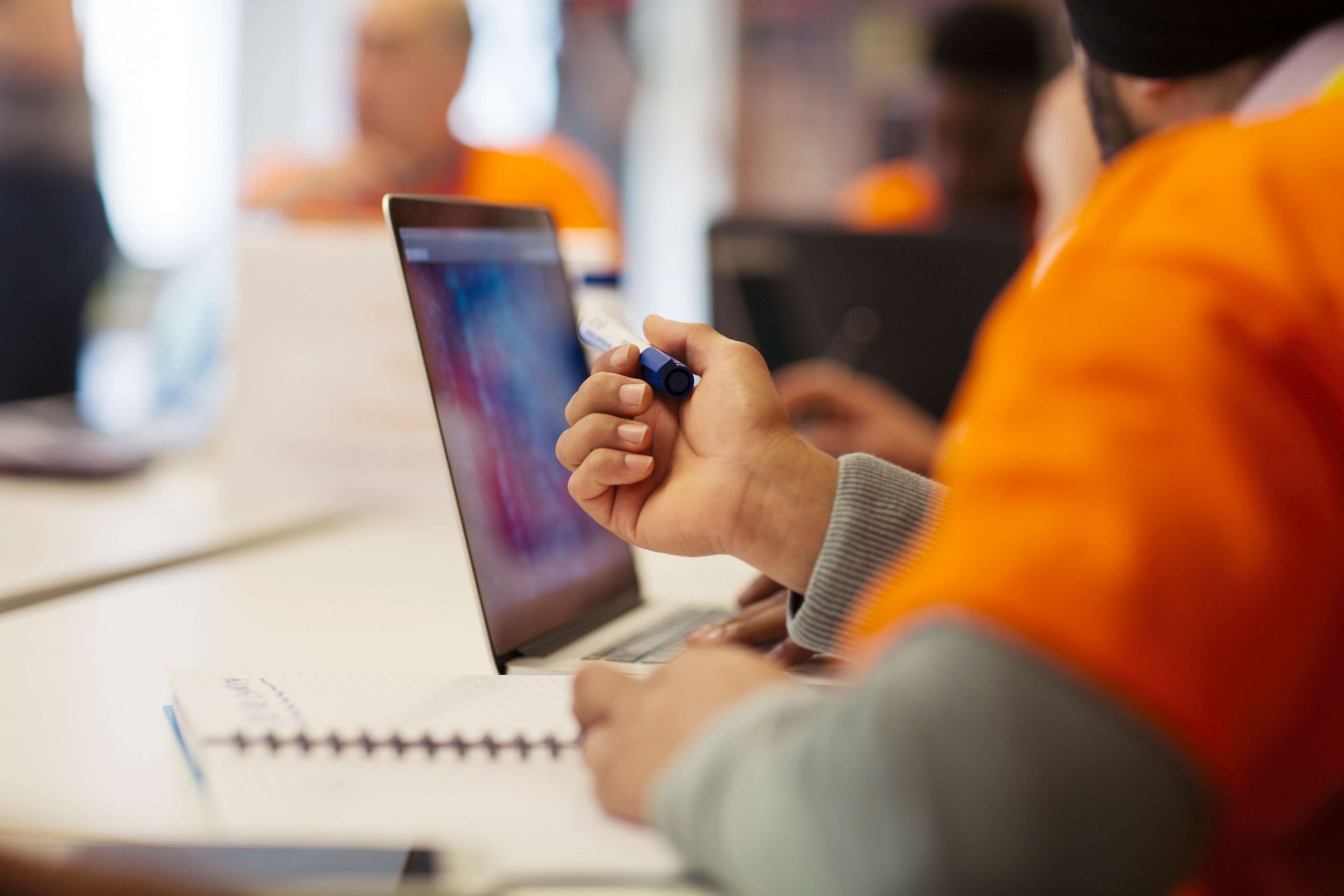 Hacker at laptop coding for charity at hackathon