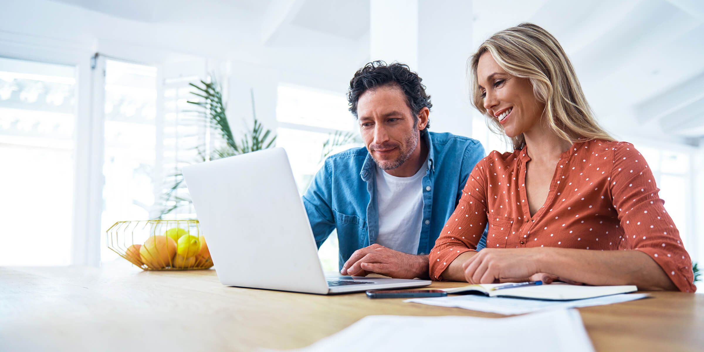 Woman and man smiling at laptop